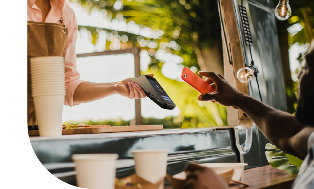 Customer paying by contactless card over a food truck counter